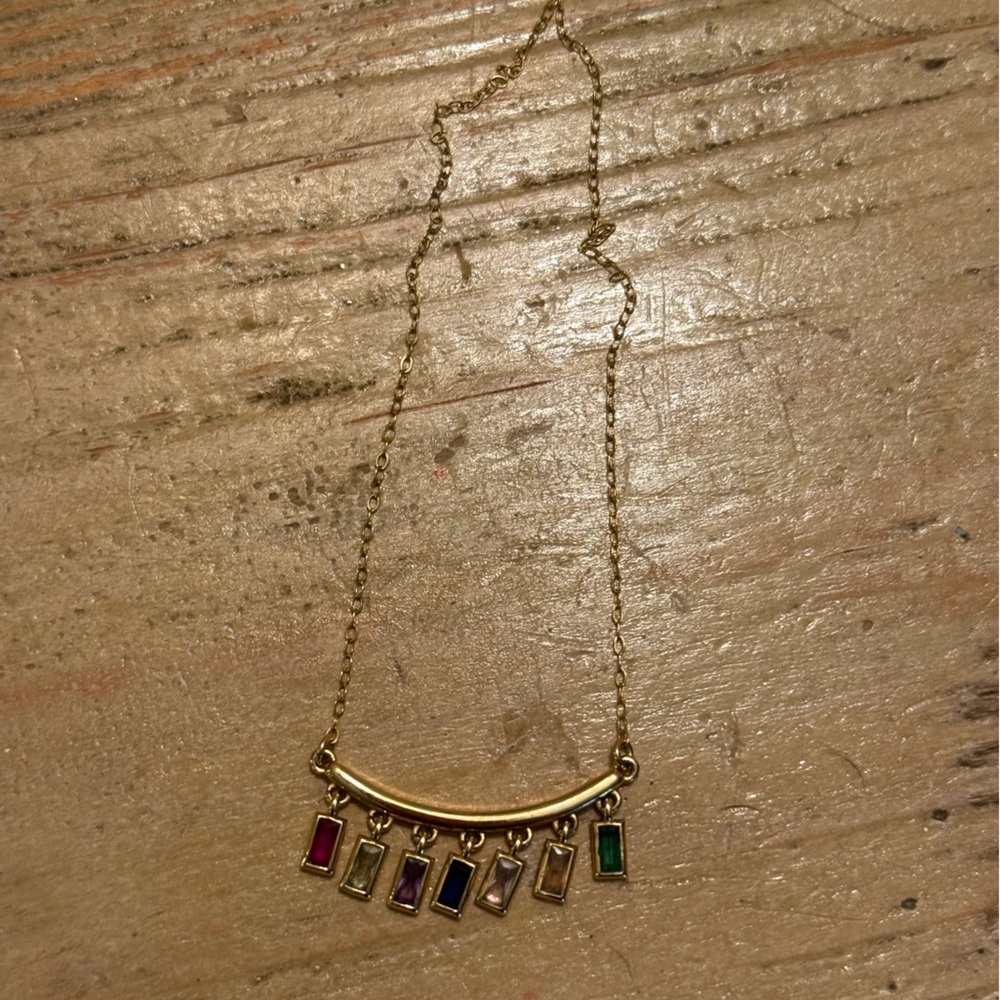 Multicolored gems 💎 on gold bar with elegant gold chain